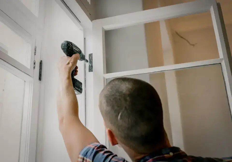 A man installing a new energy efficient window.