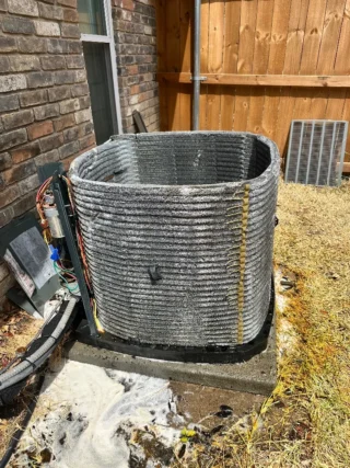 Heavily soiled air conditioning condenser unit with dirt and debris buildup requiring professional cleaning in Mesquite area.