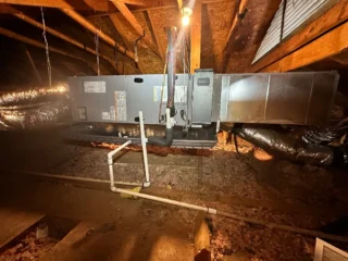 New R454B heat pump system installed in Mesquite attic with ductwork and refrigerant lines connected