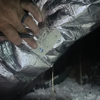 Admirable Air technician in Mesquite testing HVAC system pressures with diagnostic equipment on ductwork
