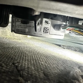 Close-up of a replacement blower fan motor with warranty label installed in an HVAC system during repair in Mesquite, TX area.