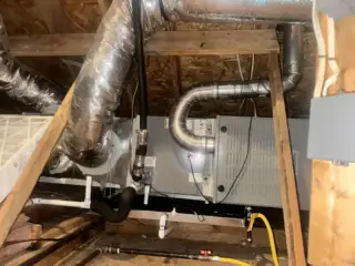 New HVAC system installation in Mesquite attic showing indoor unit, ductwork, and electrical connections